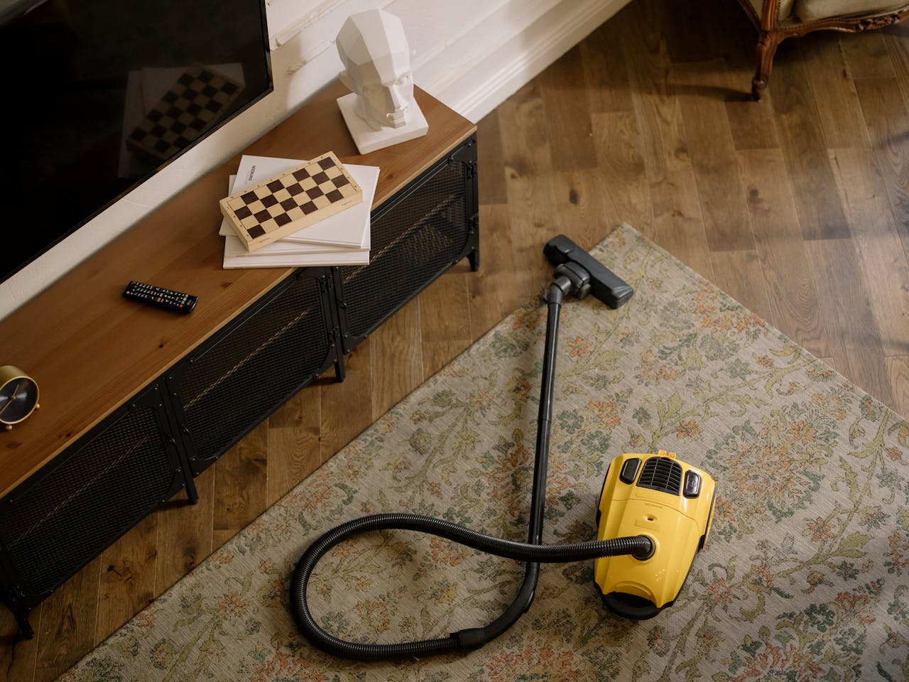 portfolio-01 Warm living room scene featuring a yellow vacuum on a floral carpet with a vintage vibe.